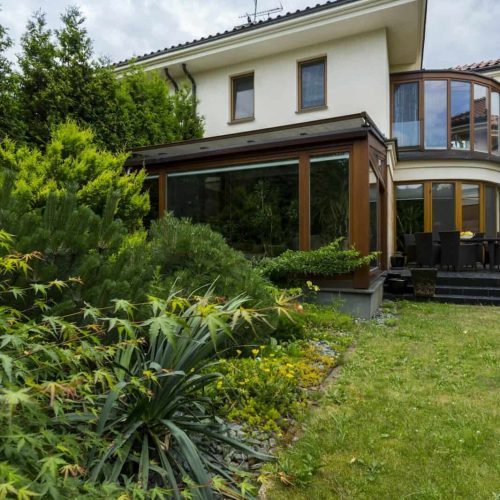 Exterior of house surrounded by lush greenery