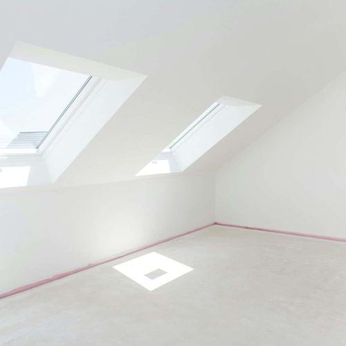 Loft refurbishment - empty room with skylight ready for renovation and new floor